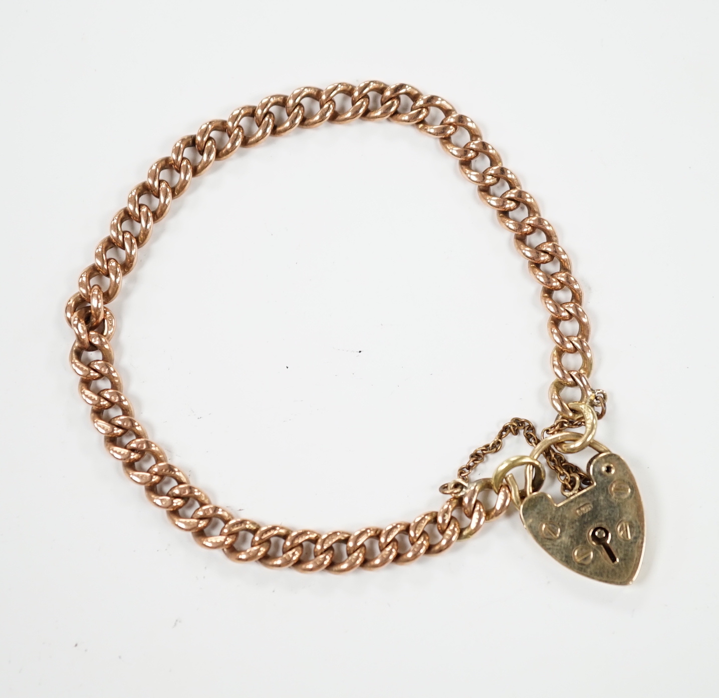 A 9ct gold curb link bracelet, with heart shaped padlock clasp, 18cm, 15.6 grams.